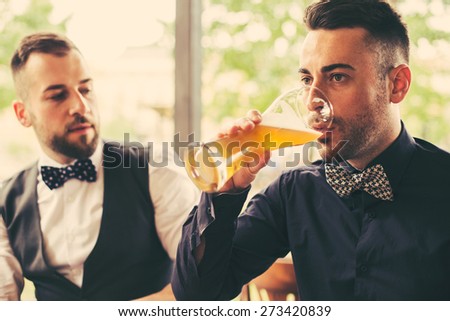 Two hipster friends Drinking beer