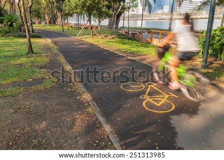Bike lane in a park with cyclist in motion