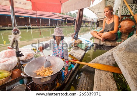 BANGKOK, THAILAND 28 MARCH 2015; Unidentified foreigner buying Pad Thai from sailor who making food on a boat at  Amphora, Thailand on 28 March 2015.