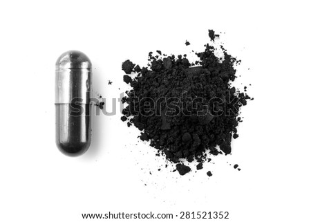 Activated charcoal capsule and powder isolated on white