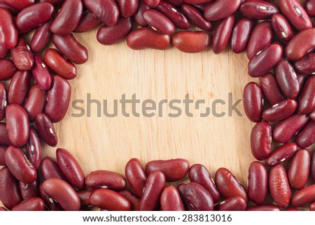 Background of red kidney beans with wooden texture in the center