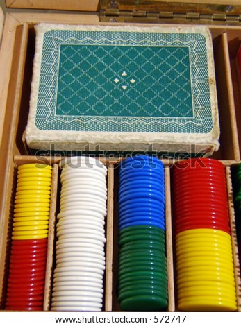 an old box with a poker deck and chips