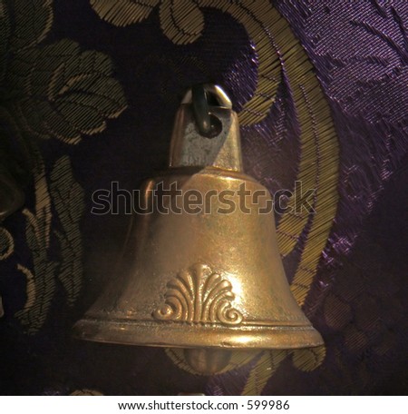 golden bell attached to purple and gold tissue