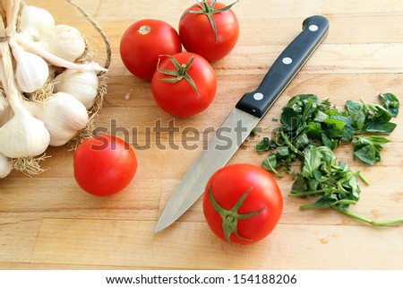cutting board with tomatoes and knife