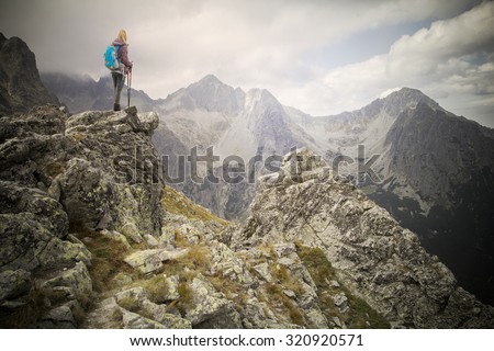 woman adventure hiker on mountain summit