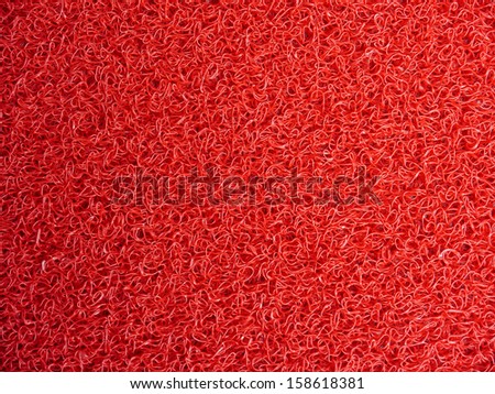 Red door mat texture background.