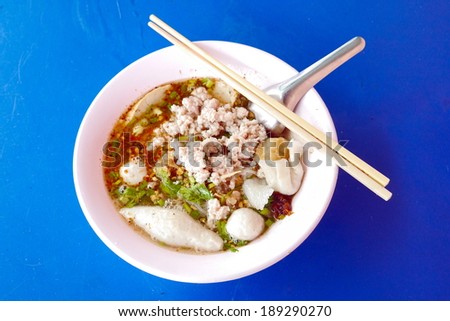 Pork noodle thai food on blue table background.
