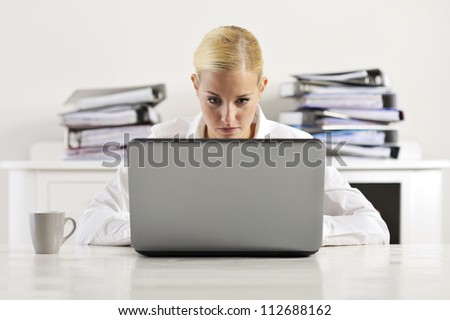 blonde woman working on a computer.