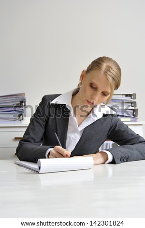 Woman making notes in an office environment, Noting secretary