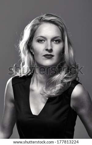 Portrait of a long haired blonde woman, processed to black and white with no skin retouche.