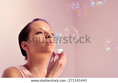 Mixed race female playing with soap solution