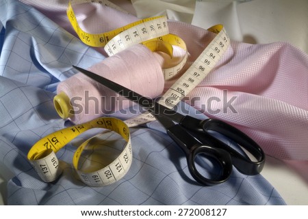 scissors, skein of yarn, tape measure and fabric