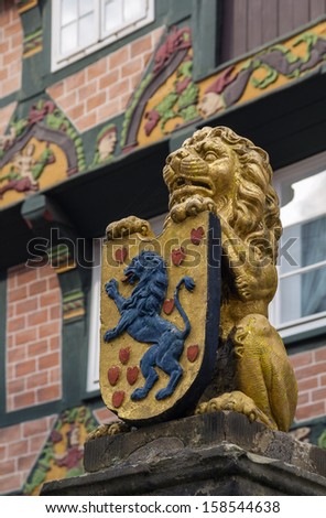figure of a lion with the coat of arms on the street in the city Celle, Germany