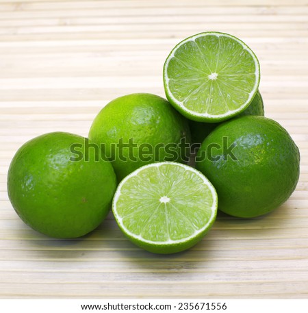 Fresh limes on bamboo background. Image of natural materials. Eco style.