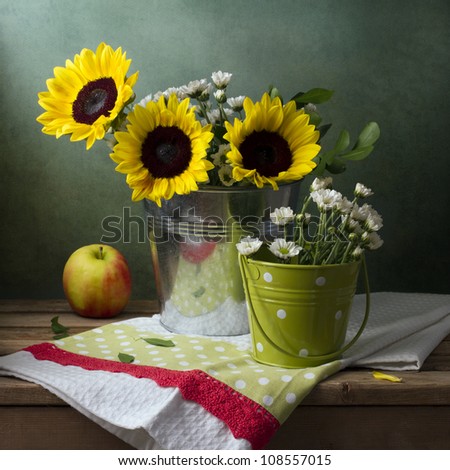Still life with sunflowers, bucket and apple