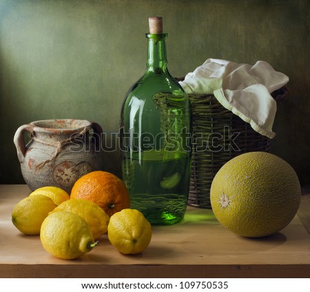Classical still life with lemons, melon and basket