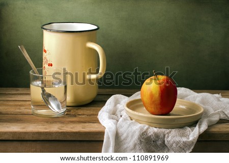 Still life with fresh apple and enamel jug
