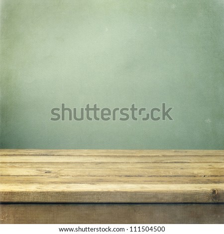 Wooden Deck Table On Green Grunge Background
