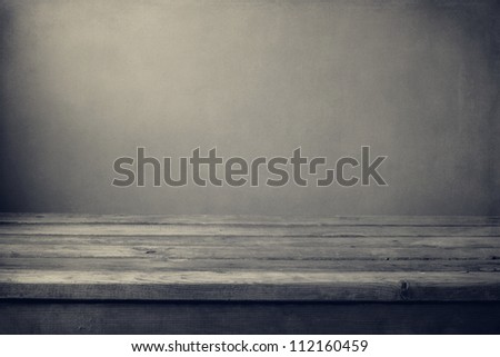 Grunge black and white background with wooden deck table