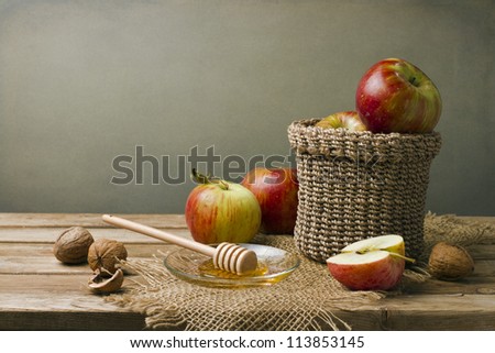 Still life with apples, walnuts and honey.