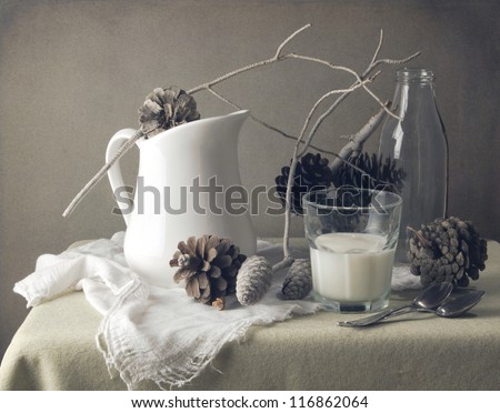 Still life with pine corn and glass of milk