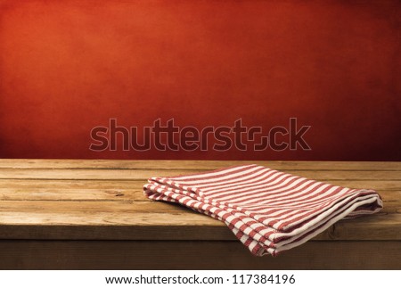 Background With Wooden Table, Tablecloth And Grunge Red Wall