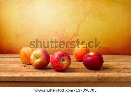 Fresh red apples over autumn background