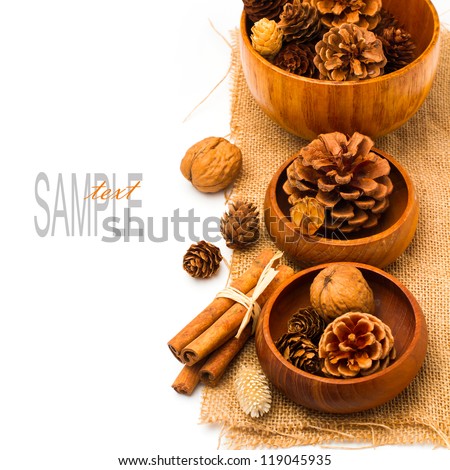 Christmas pine corn decorations in wooden bowls over white background