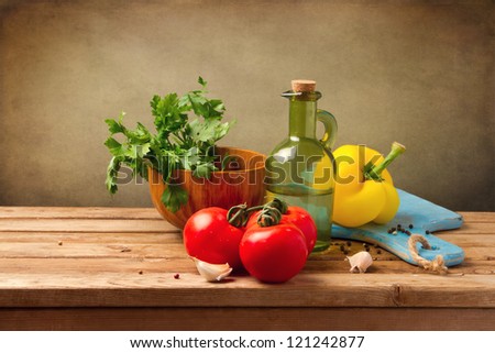 Fresh healthy vegetables on wooden table over grunge background
