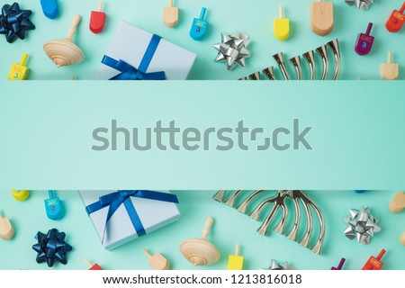 Jewish holiday Hanukkah background with menorah,  gift box and spinning top. Top view from above. Flat lay