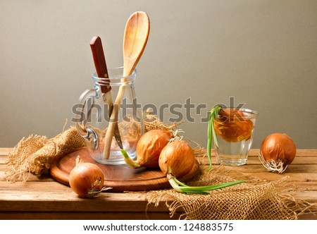 Still life with onions on wooden table