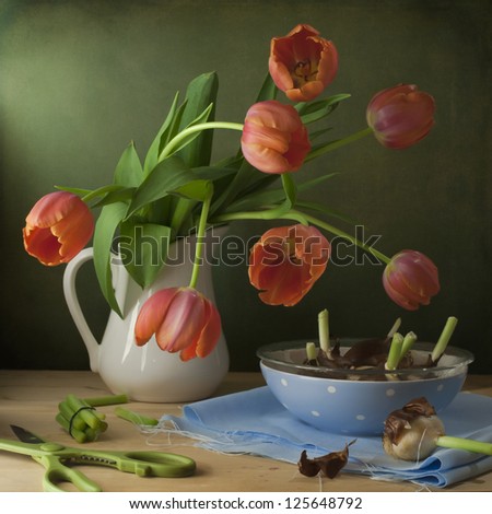 Still life with red tulips and onions