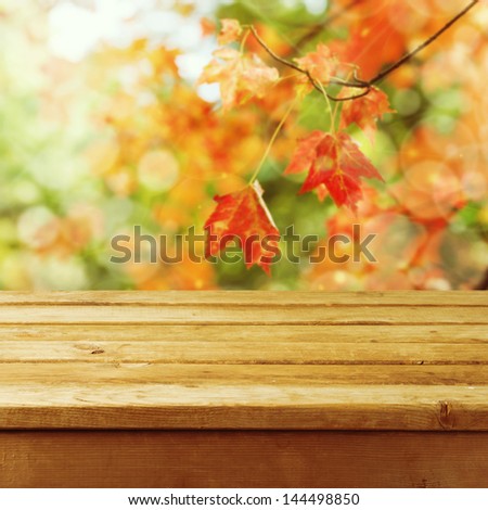 Beautiful autumn background with empty wooden deck table. Ready for product montage display.