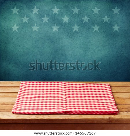 Empty wooden deck table with tablecloth for USA holidays background. Ready for product display montage