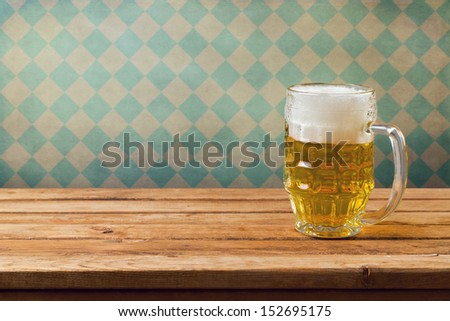 Oktoberfest Holiday. Beer On Wooden Table Over Retro Wallpaper With Bavarian Flag Pattern