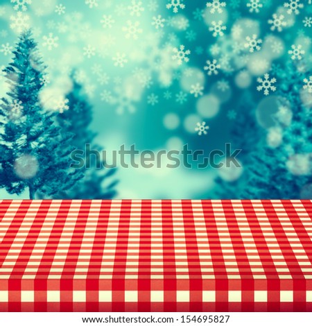Winter background with empty table covered with checked tablecloth. Ready for product montage display