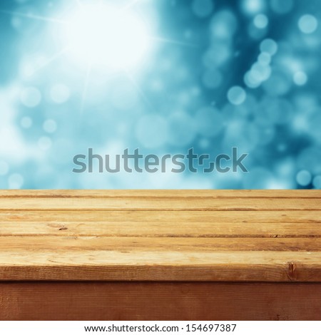 Empty Wooden Deck Table With Winter Bokeh Background. Ready For Product Display Montage. Christmas Background