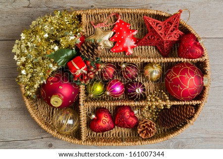 Christmas decoration in wicker box over wooden background