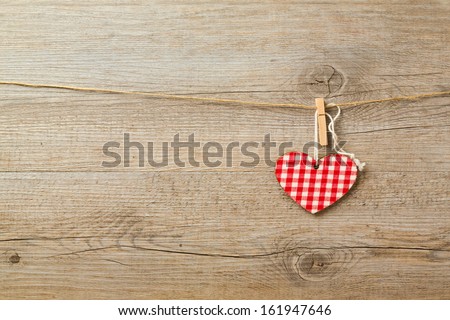 Christmas toys hanging on string over wooden background