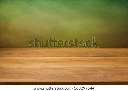 Kitchen table over green grunge background