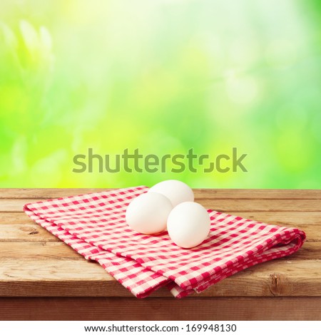 Easter holiday background with eggs on tablecloth
