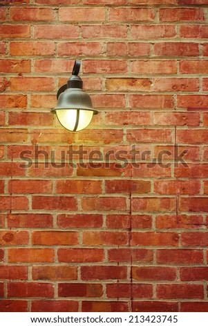 Street lamp on red brick wall
