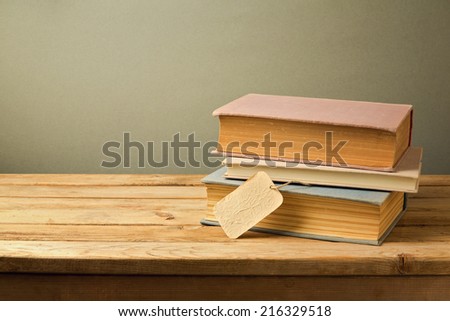 Old books with price tag on wooden table