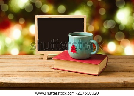 Tea and books with chalkboard over Christmas background