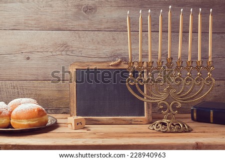 Jewish holiday hanukkah celebration with vintage menorah and chalkboard with copy space