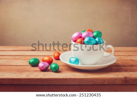 Easter chocolate eggs on wooden table. Retro filter effect