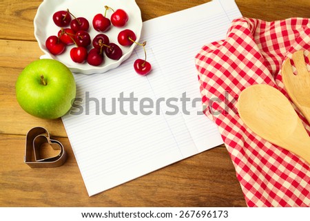Background for recipe display with blank notebook and fruits. View from above