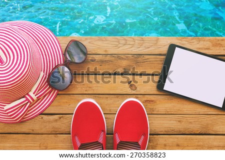 Summer holiday vacation essential objects on wooden deck. View from above