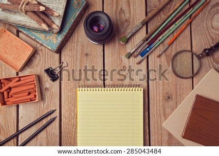 Website header design with notebook page and creative vintage objects. View from above