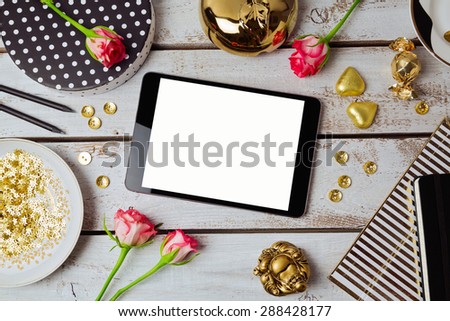 Digital tablet mock up with feminine objects. View from above